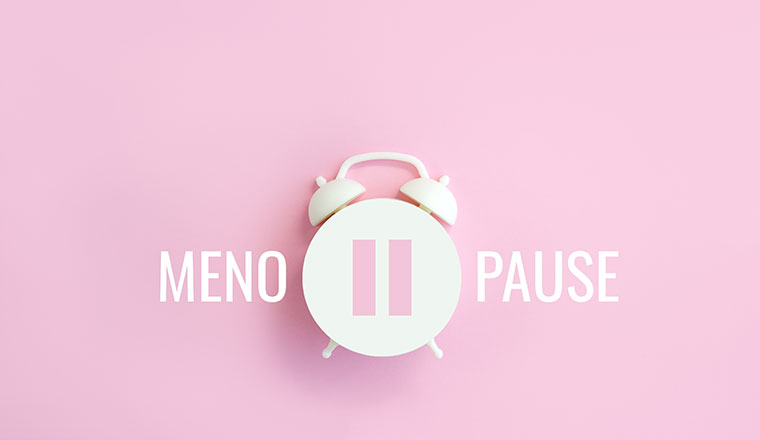 Word Menopause, pause sign on a white alarm clock on pink background