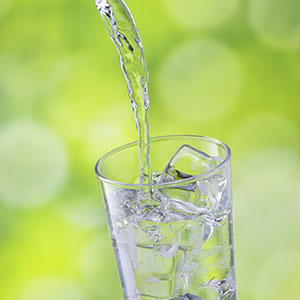 Water pouring into drinking glass