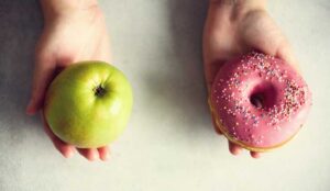 Choice concept with a healthy apple and unhealthy donut