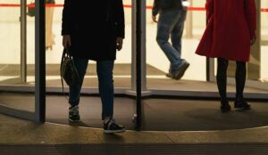 Revolving door with people - customer churn concept