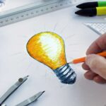 Innovation concept with hand drawing a lightbulb