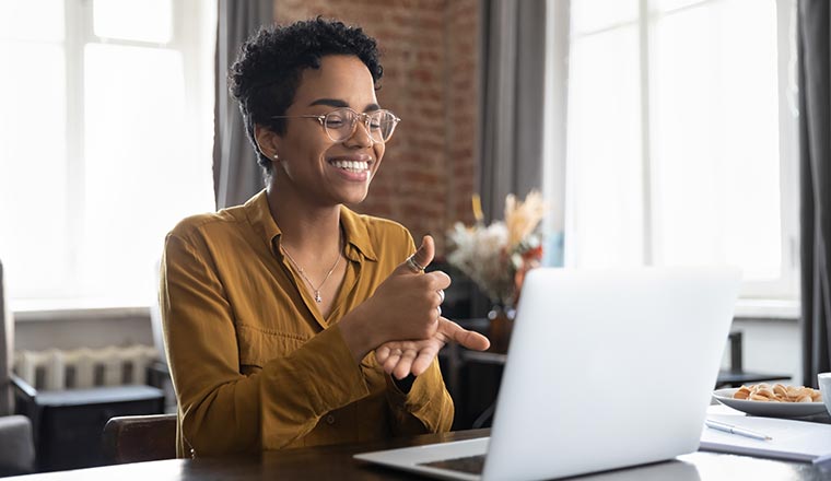 Person talking on video call, using sign language