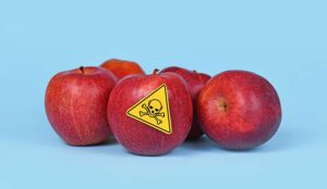 Red apples with toxic label on one