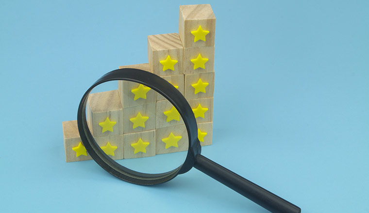 Cubes with yellow stars and magnifying glass