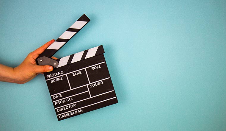 Movie clapper on blue background