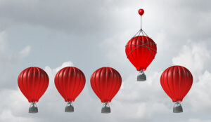 Hot air balloons racing to the top and one with a small balloon attached giving them an extra boost.