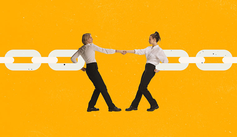 Two employees holding hands and connecting chain
