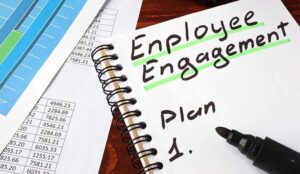 Employee engagement written in a notebook and marker.