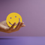 Hand Holding a Smiling Face - positive review concept