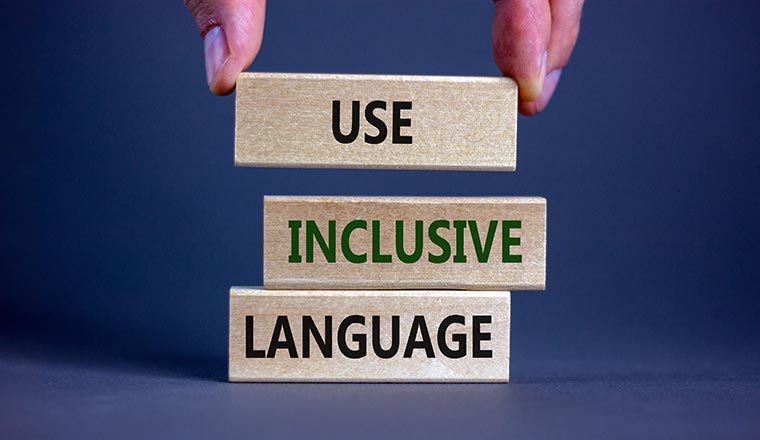 Use inclusive language symbol. Wooden blocks with words 'Use inclusive language'.