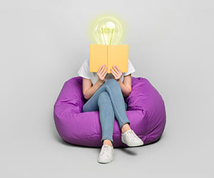 Learning concept with person with lightbulb for head reading a book