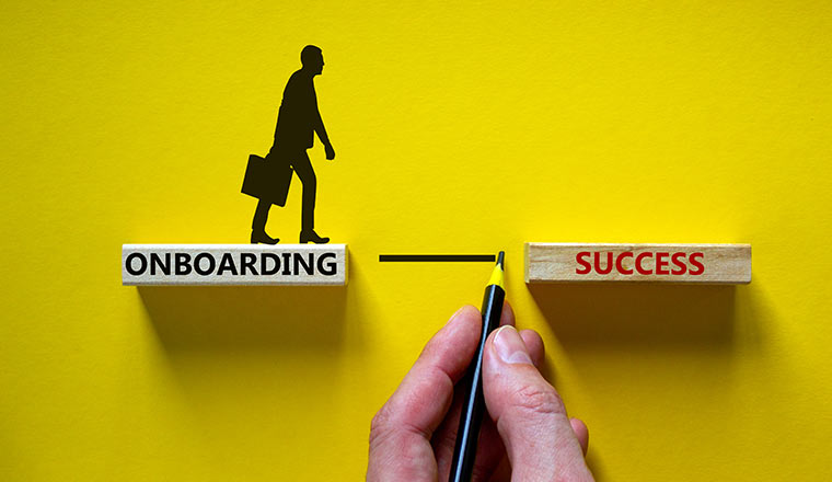 Onboarding success symbol. Wooden blocks with words 'onboarding success'.