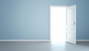 A blue wall with an open door leading to light