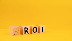 Wooden blocks with icon of growth and text "ROI".