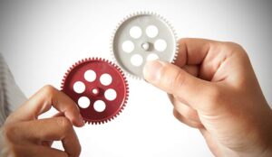 A partnership concept with hand putting together two gears