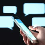 Messages in mobile screen with abstract hologram speech bubbles