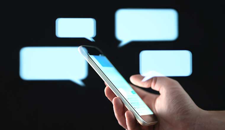 Messages in mobile screen with abstract hologram speech bubbles