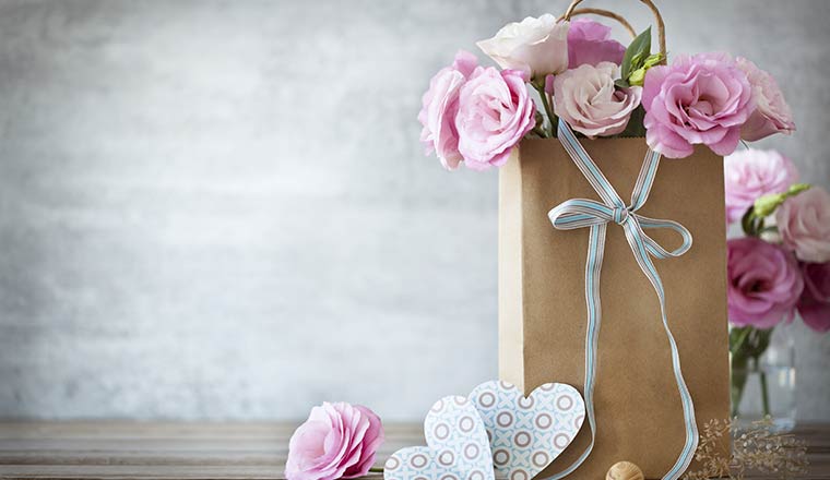 Mothers day concept with gift bag and flowers
