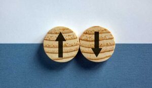 Wooden circles with arrows pointing in opposite directions.