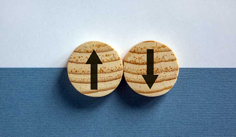 Wooden circles with arrows pointing in opposite directions.