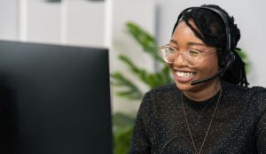 call center employee sits at desk in company in front of computer screen