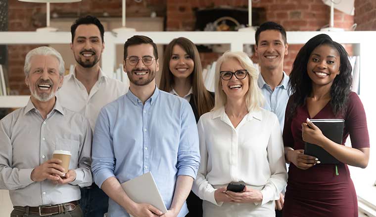 Happy diverse professional business team stand in office