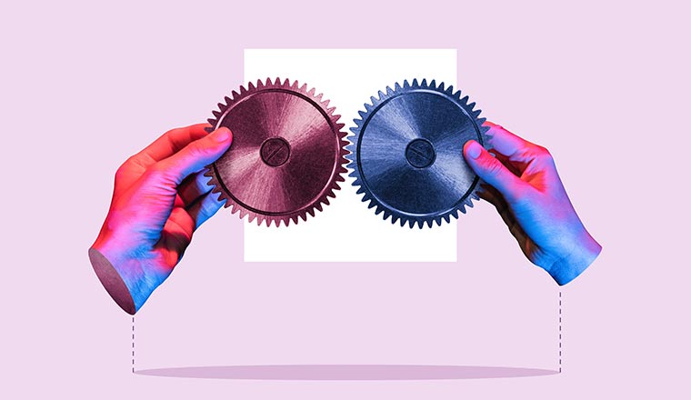 Business coherence and coordination concept with hands holding two cogs together