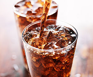 Soft drinks being poured in glass