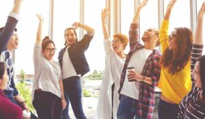 Happy employees celebrating in office