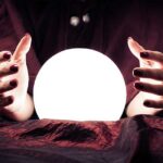 Future concept with fortune teller hands and crystal ball