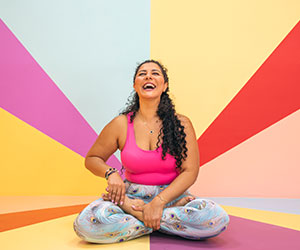 Person laughing in a yoga pose