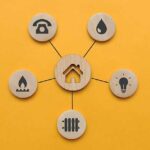 Utility icons on wooden circles surrounding a house icon