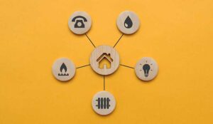 Utility icons on wooden circles surrounding a house icon
