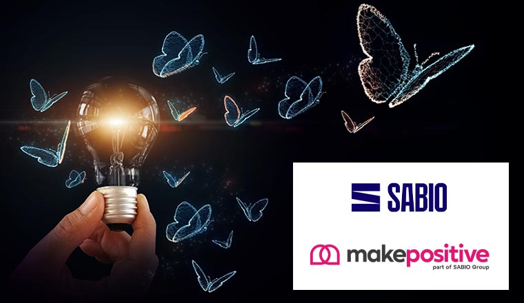 A hand holding light bulb with digital butterflies