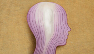 Person's head with onion layers - concept of hidden complexity