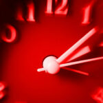 Red clock with speedy blurred effect. Concept of fast time passing.