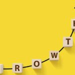 Cubes with the word growth on arrow showing increase