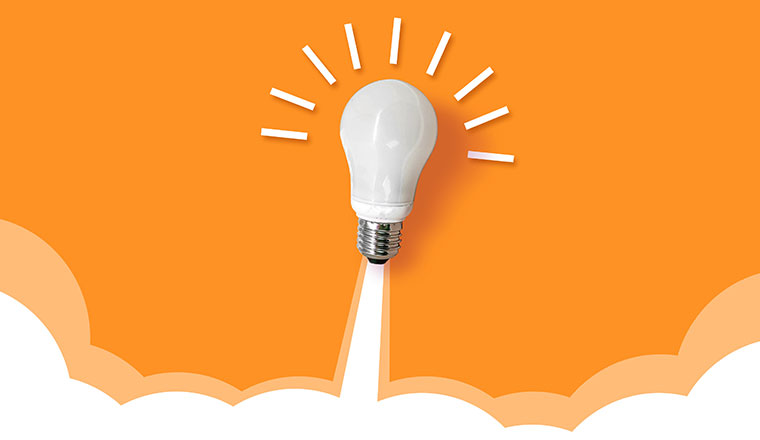 Light bulb launching like a rocket on orange background