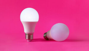 Two light bulbs, one of them in upright position and glowing. Concept of occupational burnout.