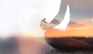 Wellbeing concept with person meditating at sunset