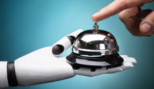 Person's Ringing Service Bell Hold By Robot - AI in customer service