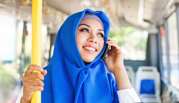 Person on a bus talking on mobile phone - getting courtesy call
