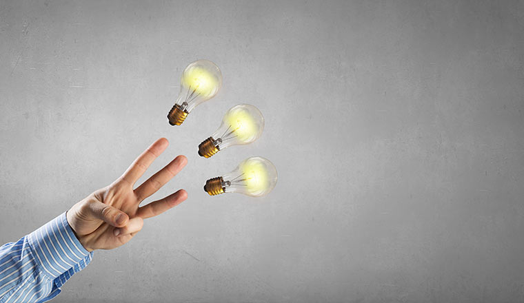 Three fingers pointing at three lightbulbs - information and ideas concept