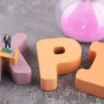 Miniature world and hourglass on KPI letters