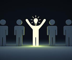 A person with a lightbulb head standing out - being present concept