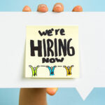 A note saying we are hiring how on a speech bubble being held