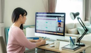 A business team using computer for an online meeting in video call.