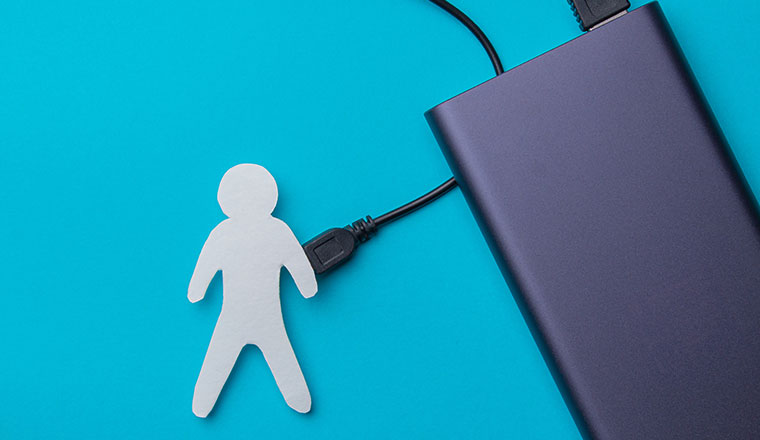 The charge of a person. Replenishment of energy. Powerbank charges a person with a USB cable