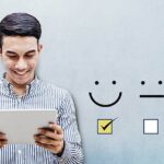 Customer Experience Concept, Happy person holding digital Tablet with a checked box on Excellent Smiley Face Rating