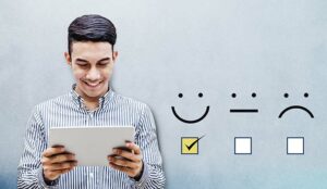 Customer Experience Concept, Happy person holding digital Tablet with a checked box on Excellent Smiley Face Rating